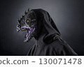 Portrait of a dragon with hooded cape over dark foggy background 130071478