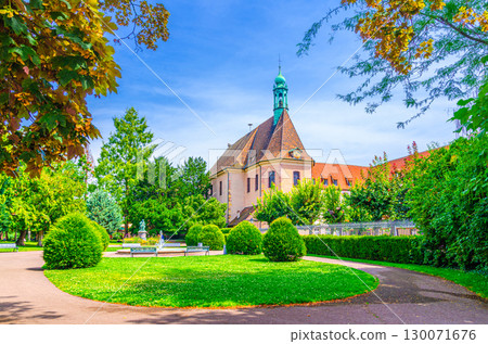 Chapelle Saint-Pierre St-Peter Chapel building and Square Adolphe Hirn small park with green lawn, bushes and trees in old town Colmar city historic centre, Alsace Grand Est region, France 130071676