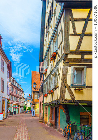 Old houses medieval buildings with half-timbered style facades with colorful walls, shutters windows on narrow street in old town Colmar city historic centre, Alsace Grand Est region, France 130071686