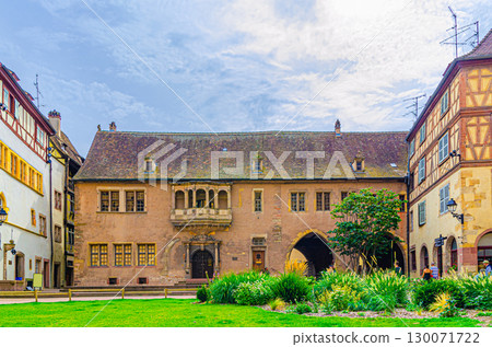 Guardhouse Ancien Corps de garde house German Renaissance architecture style building and green grass lawn on Place de la Cathedrale Cathedral square in old town Colmar city historic centre, France 130071722