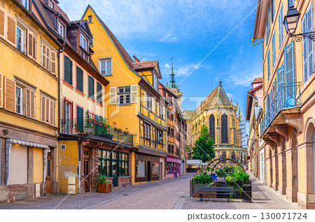 Old houses half-timbered colorful facade, medieval buildings shutters windows on Rue de Eglise street, Saint-Martin church in old town Colmar city historic centre, Alsace Grand Est region, France 130071724