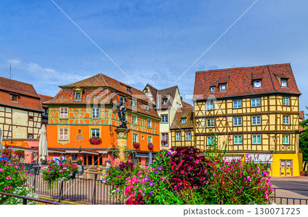 Old houses half-timbered style medieval buildings with colorful walls, Schwendi Fountain on Place de l'Ancienne Douane square in old town Colmar city historic centre, Alsace Grand Est region, France 130071725