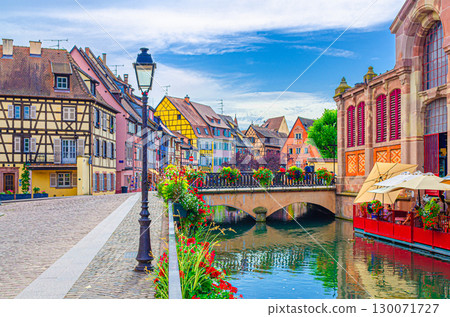 Little Venice la Petite Venise in old town Colmar city historic centre with old colorful houses and Covered market building on Quai Poissonnerie of river Lauch canal, Alsace Grand Est region, France 130071727