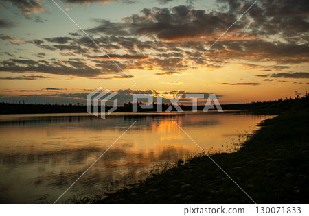 Golden sunset with clouds near evening lake 130071833