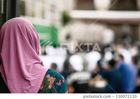 Woman Wearing Pink Hijab Watching Outdoor Prayer 130072110
