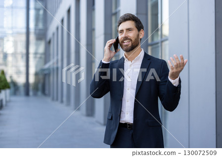 Confident man in formal attire having a phone call outdoors in cityscape. Represents professional communication, business success, and urban workplace atmosphere Confident man in formal attire having a phone call outdoors in cityscape. Represents professional communication, business success, and urban workplace atmosphere 130072509