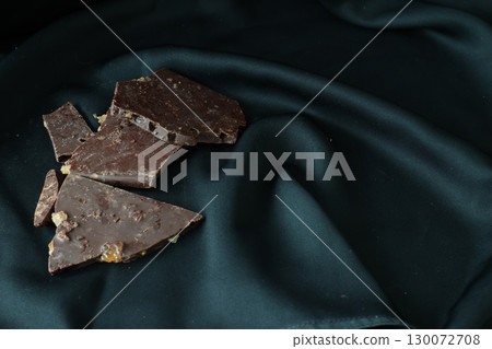 Stack of orange chocolates on a black background 130072708
