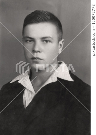 An old photo of a young man of about eighteen. Photo from 1954. USSR, Ukrainian SSR, Kharkov. An old photo of a young man of about eighteen. Photo from 1954. USSR, Ukrainian SSR, Kharkov. 130072778