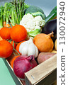 Fresh organic vegetables in wooden crate including tomatoes, onions, garlic, cauliflower, eggplant, asparagus, carrots, potatoes and broccoli. 130072940