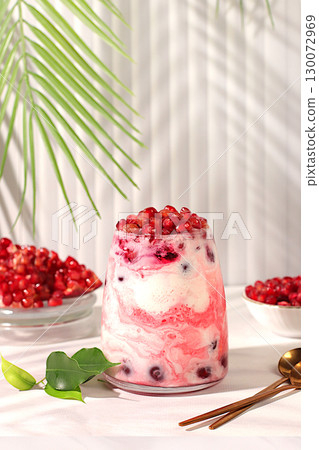 Modern still life with berries and drinks. Pomegranate yogurt with berries in a glass on an elegant table, detox diet and natural nutrition concept, healthy breakfast with ingredients, menu for cafe 130072969