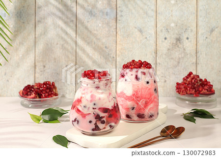 Modern still life with berries and drinks. Pomegranate yogurt with berries in a glass on an elegant table, detox diet and natural nutrition concept, healthy breakfast with ingredients, menu for cafe Modern still life with berries and drinks. Pomegranate yogurt with berries in a glass on an elegant table, detox diet and natural nutrition concept, healthy breakfast with ingredients, menu for cafe 130072983