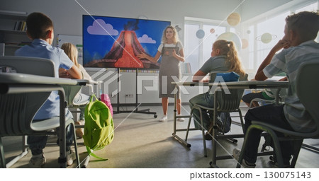 Geology Class: Female Teacher with Tablet Computer Teaching Primary School Children Using Digital Screen 130075143