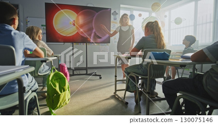 Astronomy Class: Female Teacher Explaining Solar System to Primary School Children Using Digital Screen 130075146