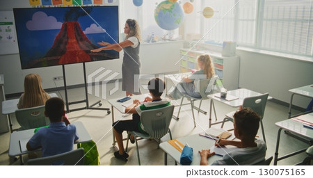Young Students Sitting at the Desks, Learning Eruption of the Volcano and Geology 130075165