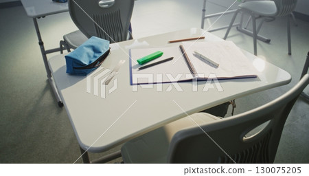 Close Up of School Desk with Student School Supplies: Pencil Case, Pens and Pencils, Notebook for Writing Close Up of School Desk with Student School Supplies: Pencil Case, Pens and Pencils, Notebook for Writing 130075205