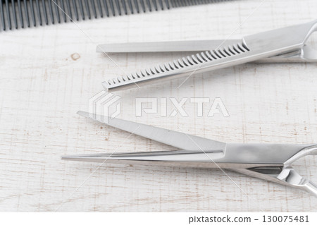 Close-up of the cutting edges of haircutting scissors and thinning shears 130075481