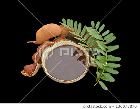 Tamarind paste, fresh tamarind and leaves are herbs for health.photo on black background. Tamarind paste, fresh tamarind and leaves are herbs for health.photo on black background. 130075870