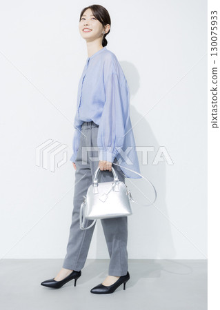 Young woman wearing a light blue shirt 130075933