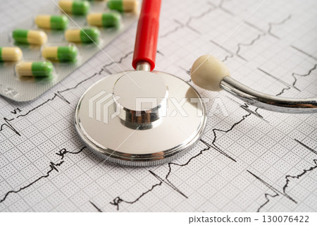 Stethoscope on electrocardiogram ECG with capsule drug, heart wave, heart attack, cardiogram report. Stethoscope on electrocardiogram ECG with capsule drug, heart wave, heart attack, cardiogram report. 130076422
