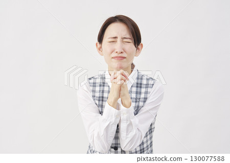 Female office worker pleading on white background 130077588