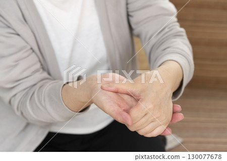 Senior woman's hands suffering from pain and stiffness Senior woman's hands suffering from pain and stiffness 130077678