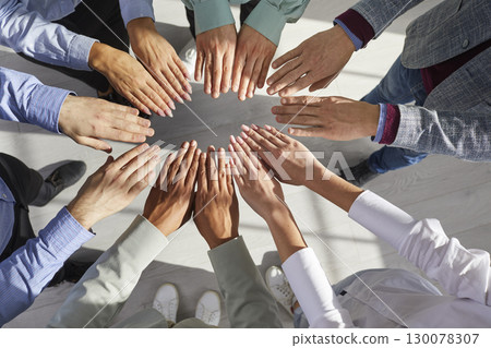 Team of diverse, multiracial business people joining and holding their hands together Team of diverse, multiracial business people joining and holding their hands together 130078307