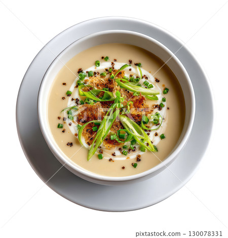 Creamy Leek and Potato Veloute Soup Served with Leek Ash Crisps and Chive Cream in Shallow Bowl 130078331