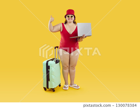 Happy cheerful chubby woman using laptop to find summer tour and book hotel for summer vacation. 130078384