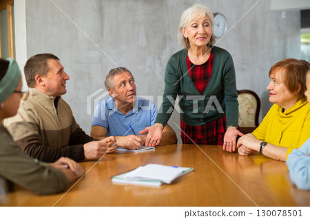 Mature female professor giving lecture to elderly students Mature female professor giving lecture to elderly students 130078501