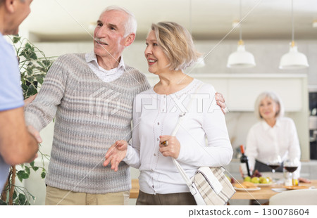 Couple of elderly man and woman greeting friends Couple of elderly man and woman greeting friends 130078604