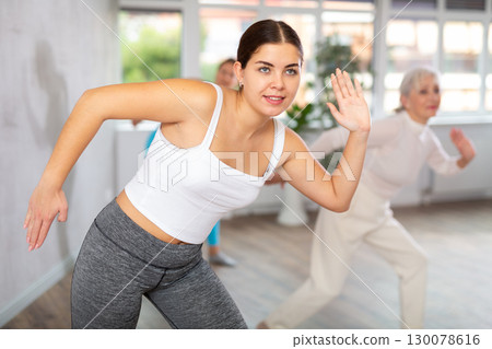 Different ages women learning swing steps at dance class 130078616