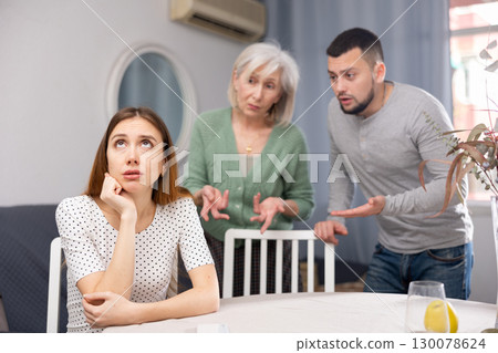 Man and mature woman scolding young woman Man and mature woman scolding young woman 130078624