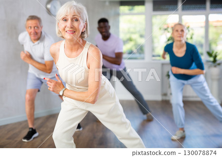 Mature men and women practicing Hip-hop dance in training hall 130078874