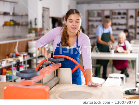 girl is working with machine clay press roller 130079077