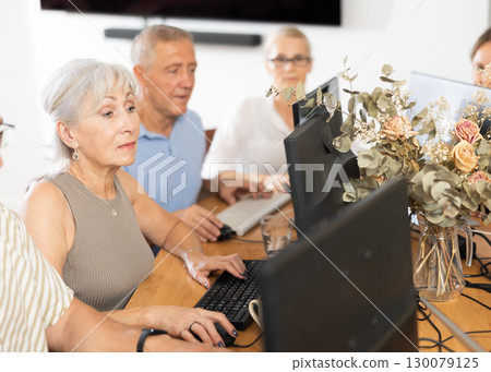 Group of older people studying on computer course Group of older people studying on computer course 130079125