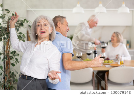 Couple of elderly man and woman dancing in kitchen Couple of elderly man and woman dancing in kitchen 130079148