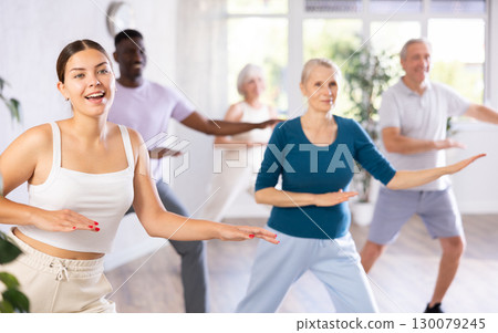 Men and women of different ages practicing Hip-hop dance in training hall 130079245