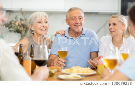Happy elderly friends spending free time together in kitchen of nursing home - having lunch and chatting Happy elderly friends spending free time together in kitchen of nursing home - having lunch and chatting 130079258