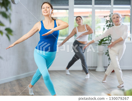 Adult woman dancing in fitness studio 130079267