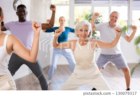 Mature men and women practicing Hip-hop dance in training hall Mature men and women practicing Hip-hop dance in training hall 130079317