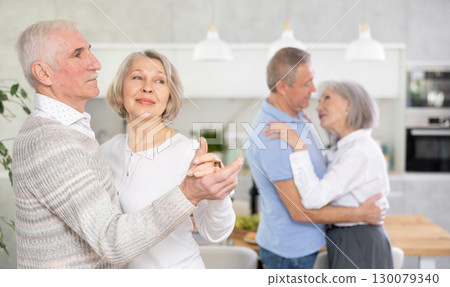 Couple dance at house party in an apartment for elderly friends Couple dance at house party in an apartment for elderly friends 130079340