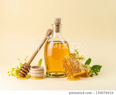 Honey Jar with Dipper and Honeycomb on Yellow Background Honey Jar with Dipper and Honeycomb on Yellow Background 130079419