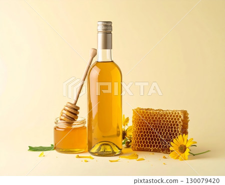Honey Jar with Dipper and Honeycomb on Yellow Background Honey Jar with Dipper and Honeycomb on Yellow Background 130079420