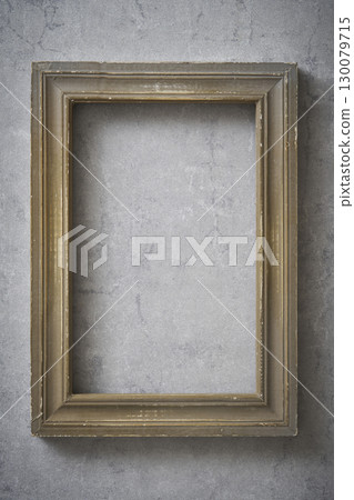 Antique frame hanging on a concrete wall 130079715