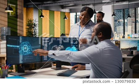 Coworkers use AI tech to make wind turbine more sustainable, reducing carbon footprint. RD experts brainstorming, testing eco friendly windmill parts with artificial intelligence, camera A 130079830