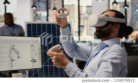 RD department researcher using VR headset to study solar clean energy systems. Engineer using virtual reality simulation to improve photovoltaics carbon footprint, camera B 130079913