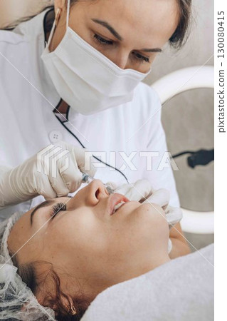 professional aesthetician performs a meticulous skin treatment professional aesthetician performs a meticulous skin treatment 130080415