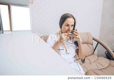 clinician takes a tea break, showcasing the importance of relaxation and mental well-being 130080429
