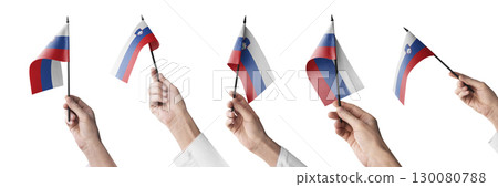 The Slovenia flag in hand in different angles on a white background The Slovenia flag in hand in different angles on a white background 130080788