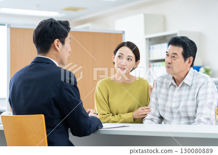 Parents and children consulting with an advisor Parents and children consulting with an advisor 130080889